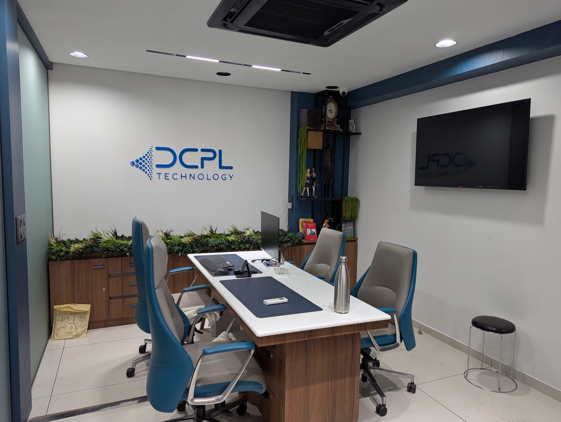 The DCPL meeting room with the DCPL Technology logo wall